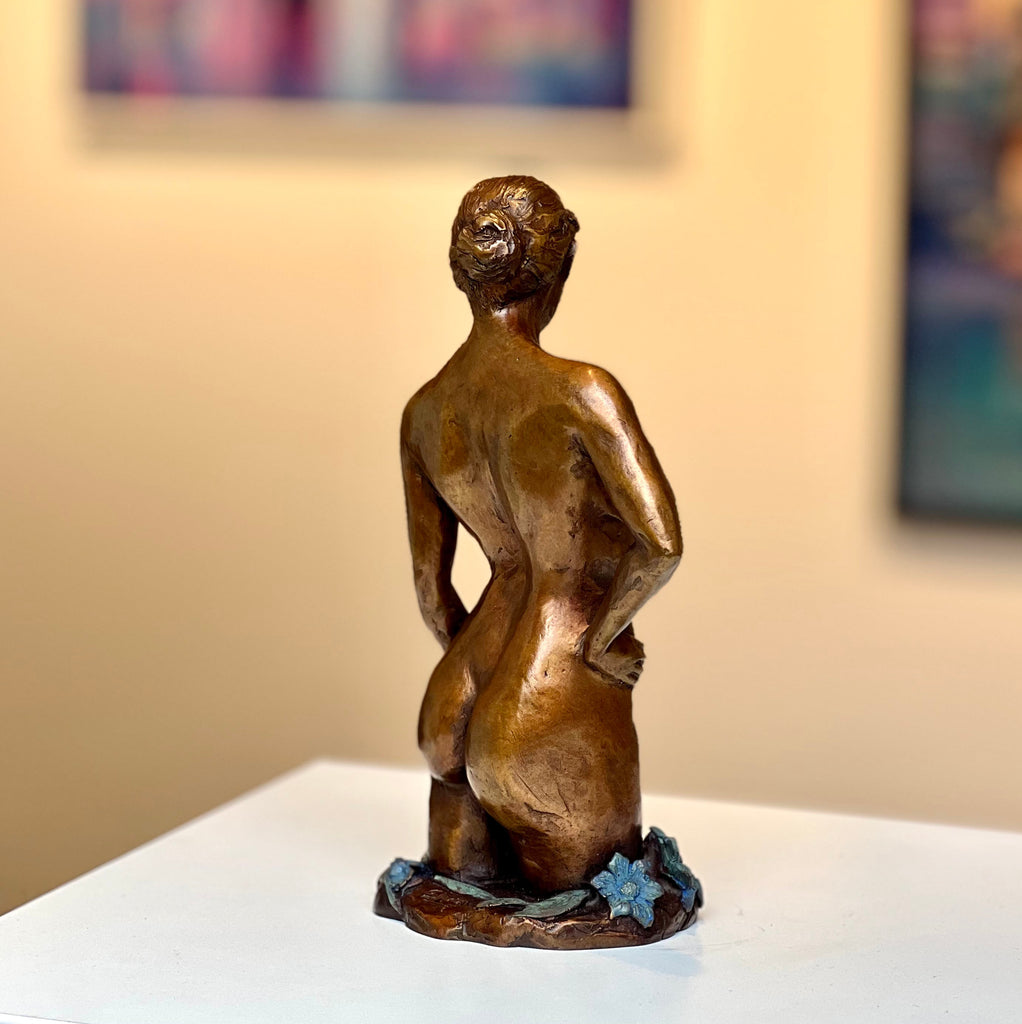 Bronze female nude and flower sculpture