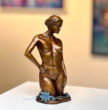 Bronze female nude and flower sculpture